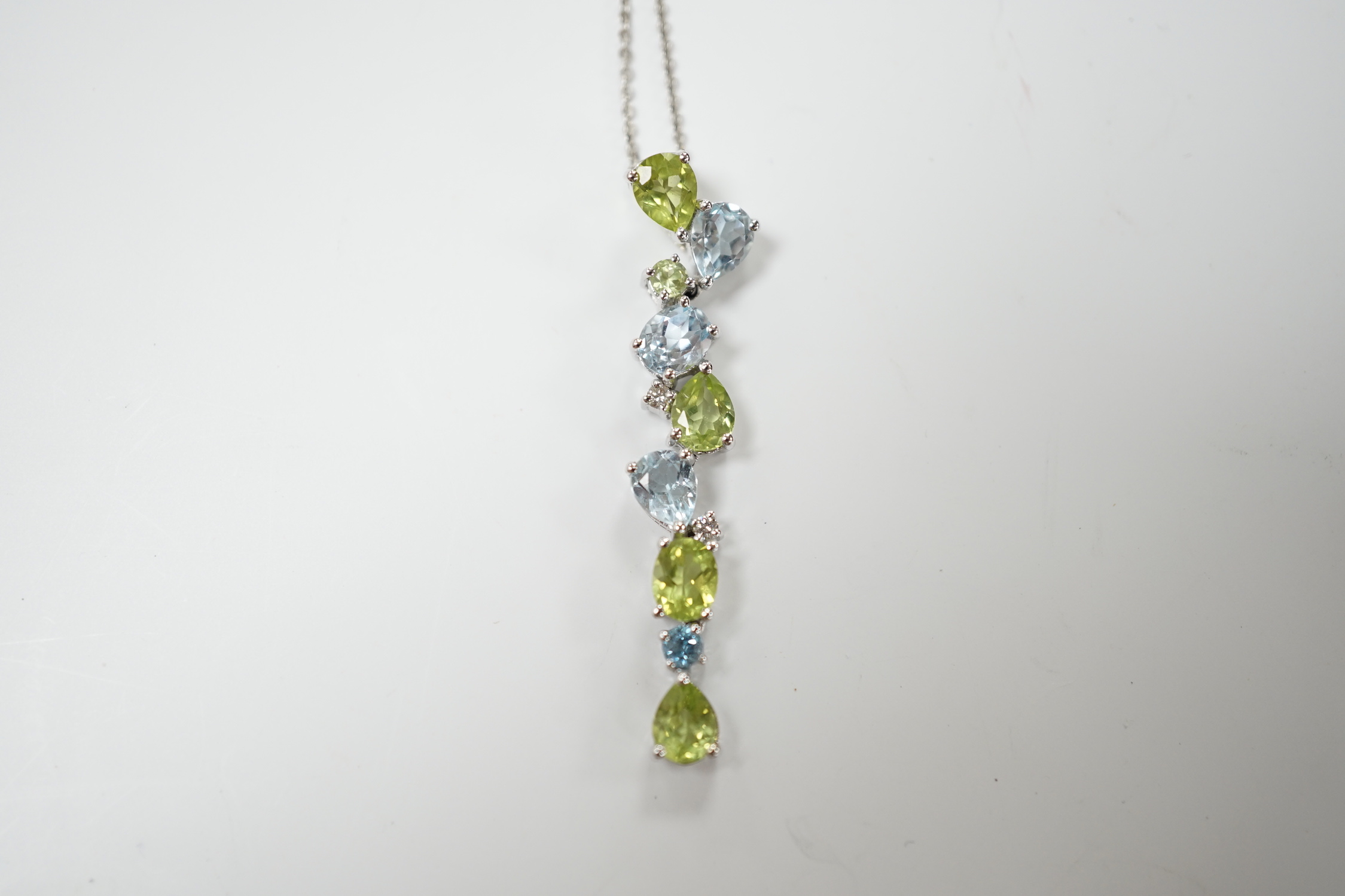 A modern 9ct white gold, peridot and blue topaz set pendant, 37mm, on a 375 chain, 40cm, gross weight 3.4 grams.